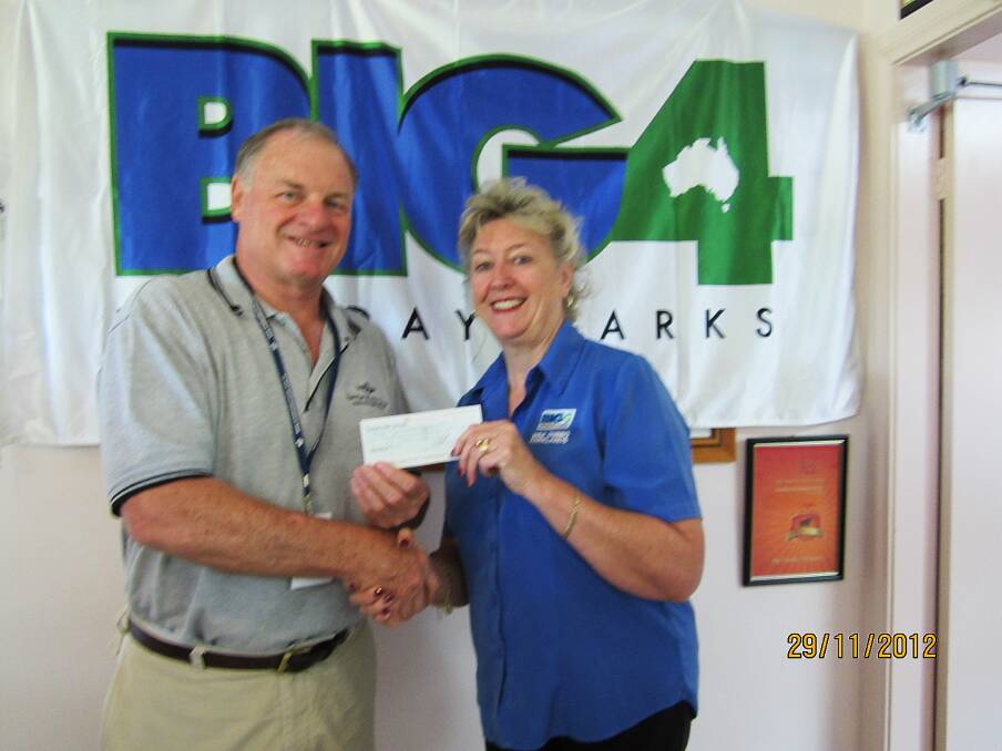 Royal Flying Doctors Service Director Terry Clark received a cheque for $300 from BIG4 manager Dubbo Parklands Deidre Kernahan.