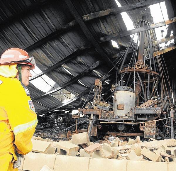 Captain of Wongarbon Rural Fire Service brigade Carole Bailey overlooks the burnt out shed and ferris wheel.                    Photo: BELINDA SOOLE