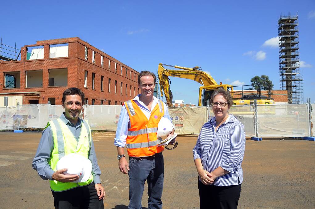 Checking out the demolition work at Dubbo Base Hospital yesterday morning are Health Infrastructure senior project director Bruno Zinghini (left) and hospital general manager Debbie Bickerton (right), in the company of Scott Galloway, senior project manager for TSA Management, the company managing the redevelopment. Photo: BELINDA SOOLE