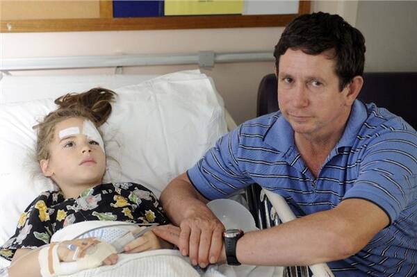Zoe Mills, 7, was playing at home with the family pet when it attacked her on Friday. The young girl and her father John Mills were flown by air ambulance to the Royal Alexandra Hospital for Children in Westmead for plastic surgery and a skin graft.