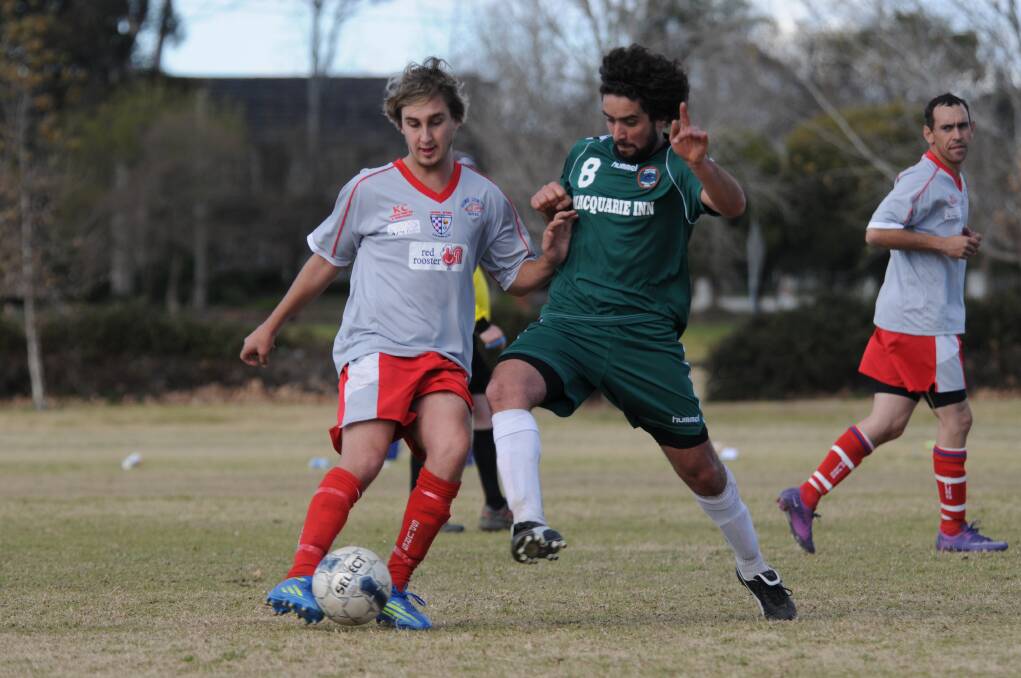 Ben Manson (Orana Spurs) and Westside's Jose Bersano in the thick of the action during a Western Premier Football League clash last season. 	Photo: JOSH HEARD