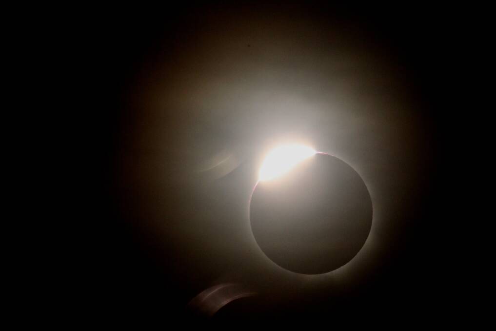 How the solar eclipse appeared at Palm Cove, near Cairns early yesterday morning. 	Photo: Peter Rae