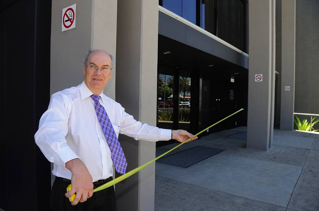 Dubbo City Council's David Dwyer measuring a four-metre smoke-free zone at the entrance to Dubbo Regional Theatre and Convention Centre ahead of the introduction of new laws on January 7.      	 Photo: Belinda Soole