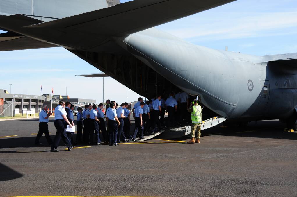 Cadets from Dubbo's Squadron 313 file into an Air Force Hercules bound for the Warbirds Downunder air show at Temora on Saturday. Photo: CHERYL BURKE