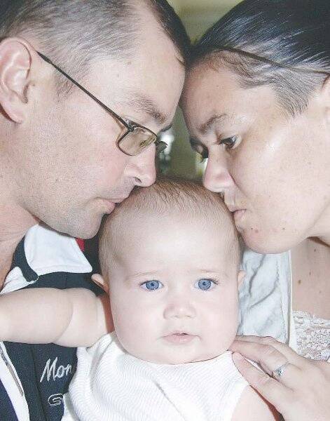 Distressed parents Stephen Winkle and Roslyn Priest with 6-month-old Martin.