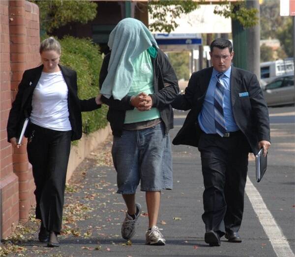Detectives escorting Matthew Allen James Dennis into Dubbo Police Station on the day of his arrest last year.