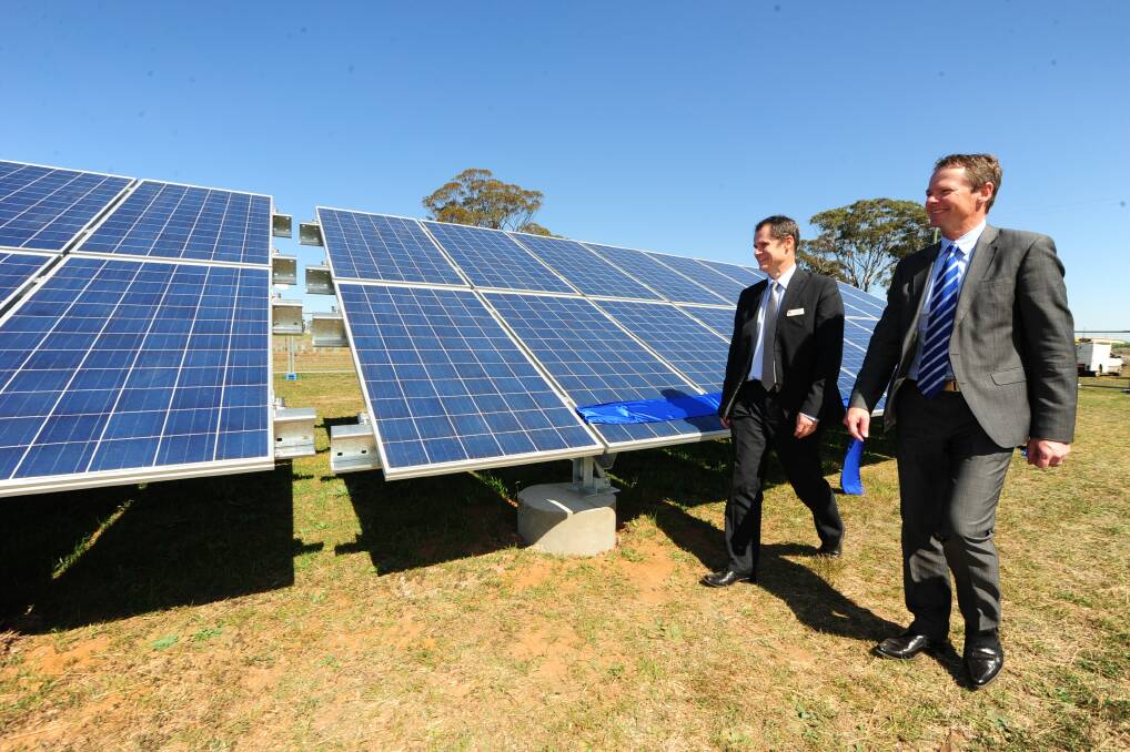 Dubbo City Council mayor Mathew Dickerson at the ribbon cutting of the five kilowatt panel collection with the help of Red Sky managing director Rohan Gillespie. 												     Photo: BELINDA SOOLE