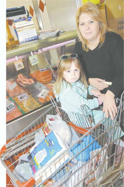 Jenny Beasley and daughter Jadey shopping for meat at Centro yesterday.
