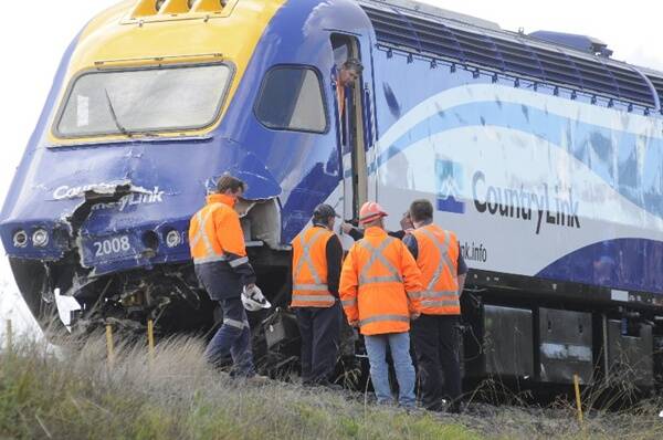 Rail officials gather around the front of the ruined XPT after the crash. Photo: Courtesy of the WESTERN ADVOCATE