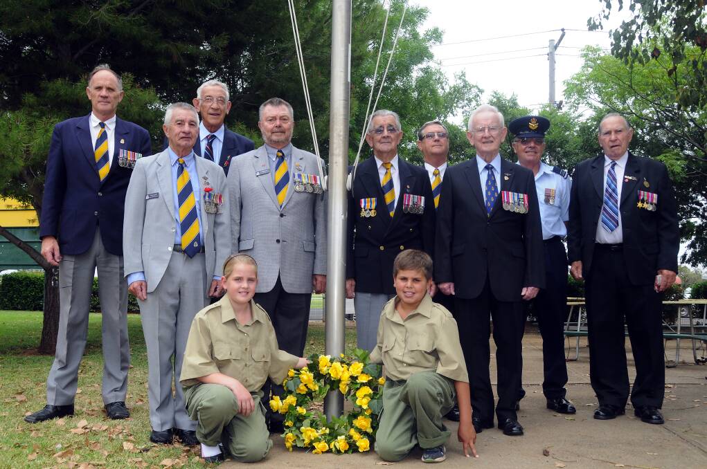 Remembering fallen heroes at a student-run service at Dubbo North Primary School yesterday were Greg Salmon, Maurice Campbell, Dave Kilsby, Tom Gray, Trevor Hampson, Ron Greenwood, Ron Stevens, Michael White, Max Swanston, along with school captains Molly Sinclair and Neil Towney-Hill. Photo: BELINDA SOOLE