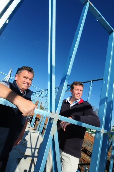 Steven Gower from Dubbo Junior Roos Rugby Union Club and Warren Saunders from Dubbo District Cricket Association inspect the progress of the new amenities block.	Photo: LOUISE DONGES