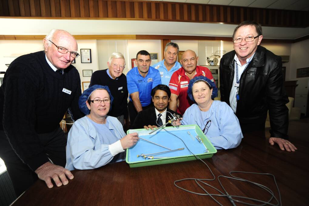 Dubbo Hospital's acting stock co-ordinator Shaye Field, urologist Dr Bala Indrajit and operating theatres manager Liz Murphy examine the TURP Tray. Watching (back, from left) are John Allen and Doug Elliott of Dubbo Prostate Cancer Support Group, Craig Biles of Club Dubbo, Guy Naden and Trevor Kennedy of the Marty Gordon Memorial NAIDOC Bowls Committee, and hospital business manager Peter Woodward. 	Photo: BELINDA SOOLE