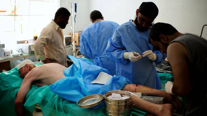 Doctors treat Abu Mahmoud in the makeshift hospital.