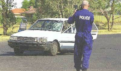 Forensic police examine the car after the hit-and-run that claimed Brendan Saul’s life.