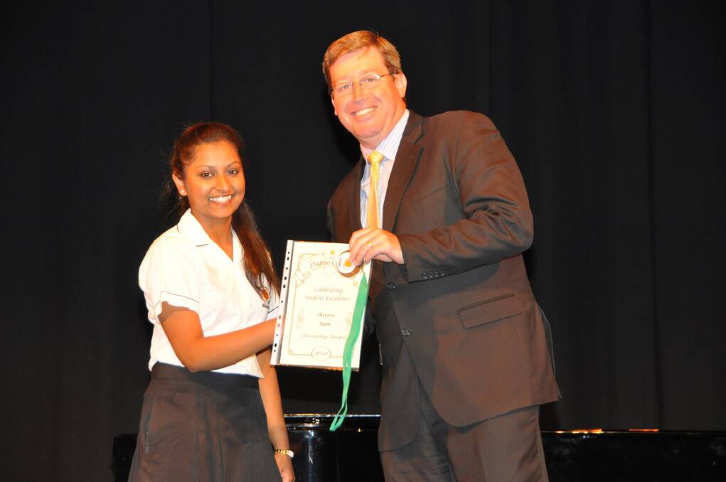 Year 12 student Shivani Ram receives her citizenship award from local member Troy Grant.