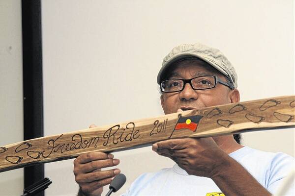 Gavin Duncan with the ceremonial stick signed by Aboriginal elders.