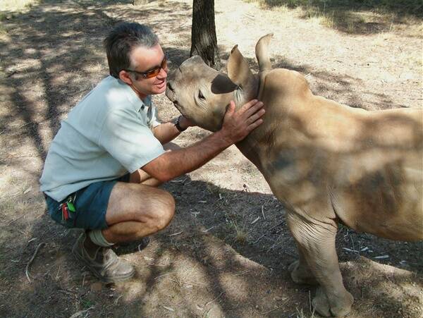 Taronga Western Plains Zoo’s senior vet Benn Bryant with hand raised white rhino calf Amira, photographed in April 2005. Amira was one of four rhinos that died suddenly at the zoo.
