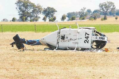 TRAGEDY: The downed Bell 206 helicopter (above) in which two men died while carrying out locust control work east of Dubbo and (inset) CareFlight staff work to stabilise a seriously injured 23-year-old Dubbo woman. Photos: IVAN McDONNELL