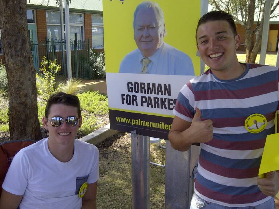 Two English backpackers photographed at the Buninyong polling booth in Dubbo handing out Palmer United Party election material. 								    Photo: SUPPLIED