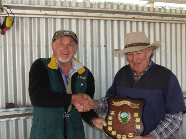 Terry Greer presents the Dubbo City Toyota Trophy to the president of the Dubbo RSL Smallbore and Air Rifle Youth Club Ray Johnson at the annual inter-club shoot with the Dubbo Pistol Club.