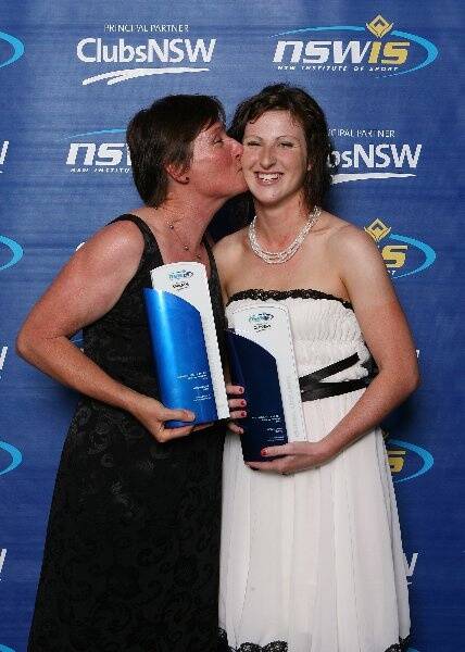 Megan Dunn is congratulated by her mother Joy after winning major awards at the New South Wales Institute of Sport dinner.