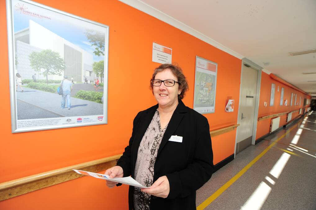 ABOVE: A crane heads towards the old boiler house on the redevelopment site at Dubbo Hospital. 
 
LEFT: Dubbo Hospital general manager Debbie Bickerton checks out the latest information on the Project Wall.