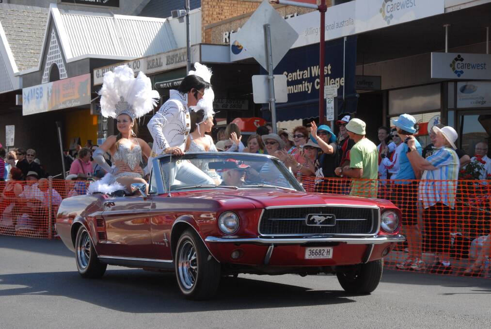 The crowd builds at the 2012 street parade of the Parkes Elvis Festival. 		        					Photo: CHERYL BURKE