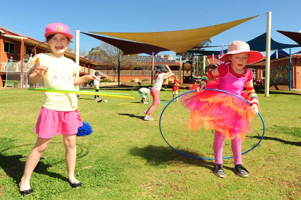 BELOW LEFT:?Emily Mann and Mia Petty get to play with hula hoops during the Relay for Addi.