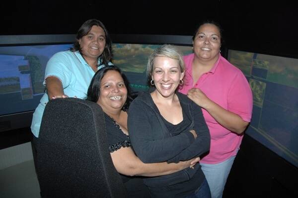 Catherine Wright with Sandra, Lisa and Marsha Riley, who are the first students in the State to use a truck simulator.