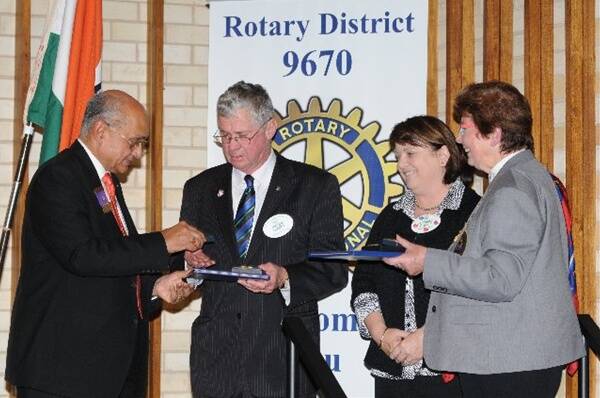 Rotary International president Kalyan Banerjee inducts Peter and Lorraine Croft as Paul Harris Fellows, watched by district 9670 governor Janette Jackson (right). 											Photo: Belinda Soole