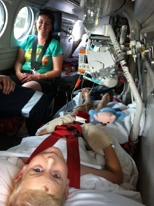 Jack Purvis with mother Brenda and the RFDS on his way to Dubbo Base Hospital after a vicious snakebite.