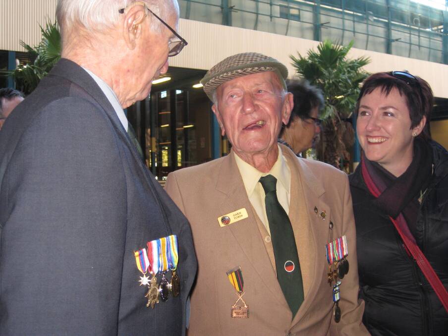 Garnet Tobin (centre) and Kerrie Phipps chatting with a unidentified man from 2/33rd battalion - who remembered serving with the late Kevin Hopkins of Dubbo just before the march in Sydney this Anzac Day, a few days before Mr Tobin's 94th birthday.