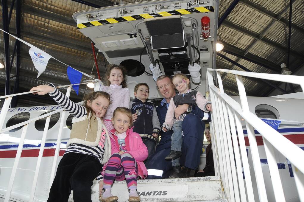 Payton and Addison Wray with Joseph and Maltida Prince, and Ella Binnie and RFDS flight nurse Michael Cook explore the King Air aircraft at the open day yesterday. 	Photos: CHERYL BURKE