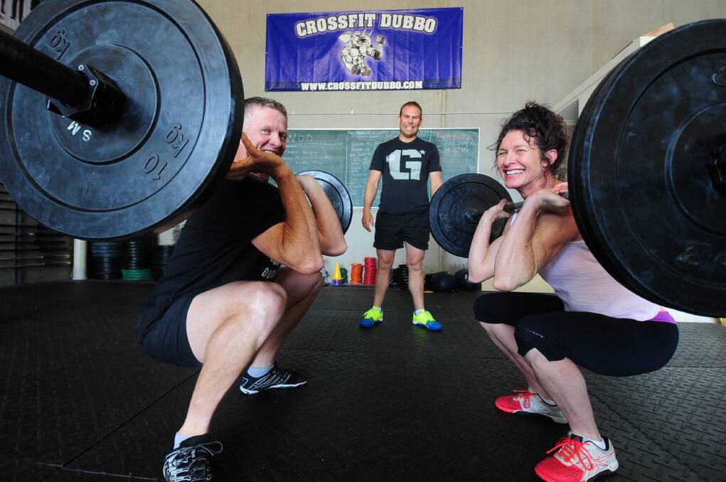 CrossFit Dubbo owner Duncan Stephens, staff member Jed Winterton and CrossFit in Pink organiser Lisa Tratt get ready for the fundraiser on Monday. 			   Photo: LOUISE DONGES