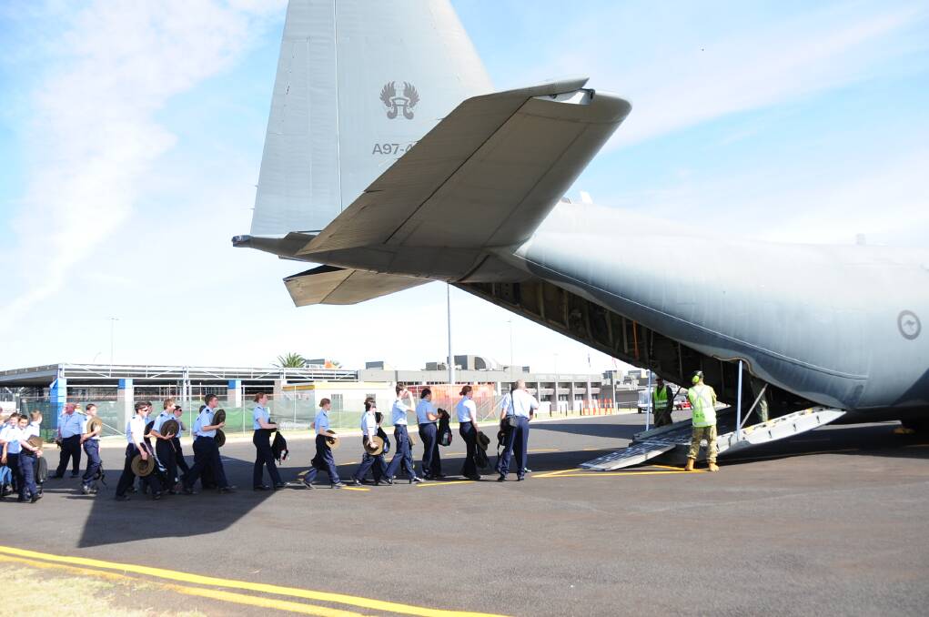 Cadets from Dubbo's Squadron 313 file into an Air Force Hercules bound for the Warbirds Downunder air show at Temora on Saturday. 
Photo: CHERYL BURKE