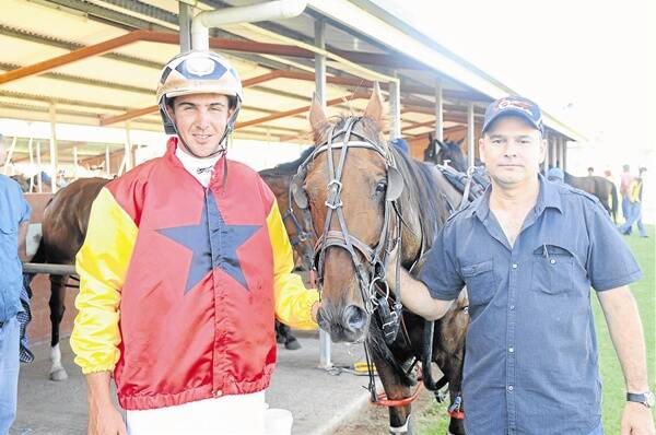 Trainer-driver Nathan Townsend with owner David Ford and their gelding Great Western Star after winning at Dubbo on Sunday night.