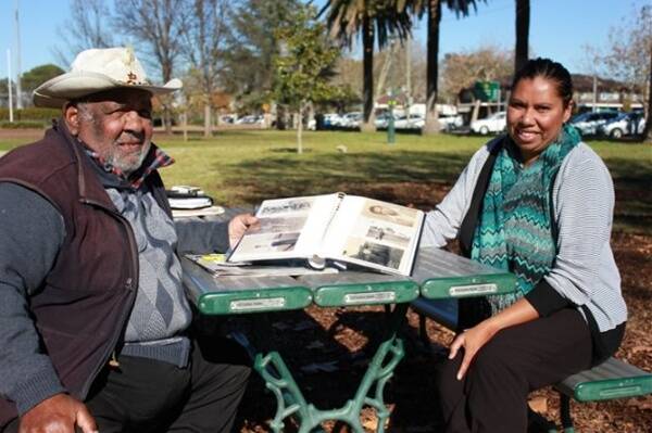 Uncle Ray Peckham and Dubbo City Council's Aboriginal Liaison Officer Grace Toomey with some of Pearl Gibbs' photo albums.