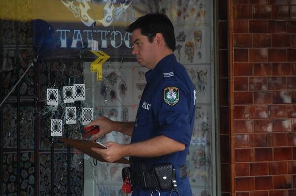 Police outside the Naked Gun III Tattoo shop in Wellington, after the drive-by shooting on May 26.