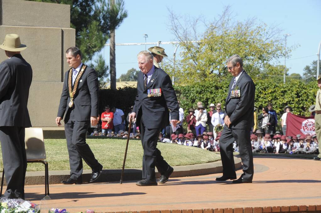 Dubbo City Council mayor, Cr Mathew Dickerson, Dubbo RSL Club patron, John Whittle, OAM and Ron Greenwood take their places prior to the post march ceremony.