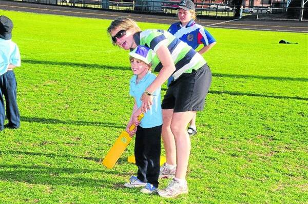 Charlotte George gets some help from Cassie Box as we look towards the start of the Milo In2CRICKET programs.                Photo: AMY GRIFFITHS