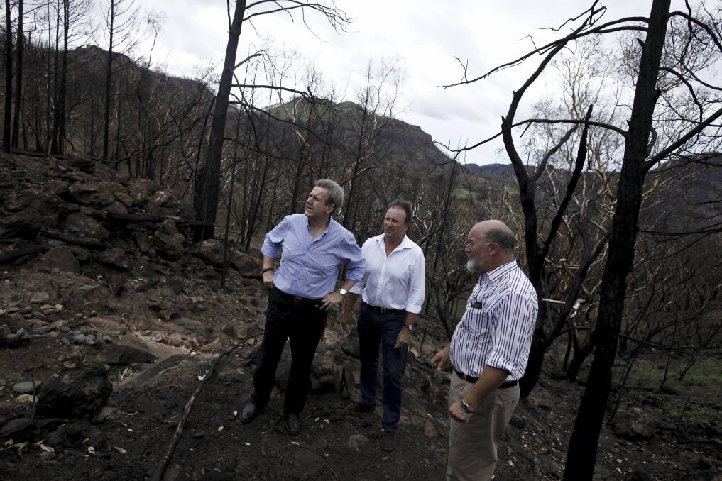 NSW premier Barry O Farrell discusses the damage caused by recent bushfires at Coonabarabran with the Member for Barwon, Kevin Humphries, and Warrumbungle Shire Council mayor Peter Shinton. 	Photo: James Brickwood