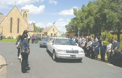 Family and friends form a guard of honour to farewell cricketing legend and “extraordinary man” Lloyd Keir.