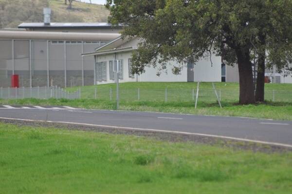 The accommodation block and four-foot high pool fence at Wellington Correctional Centre.