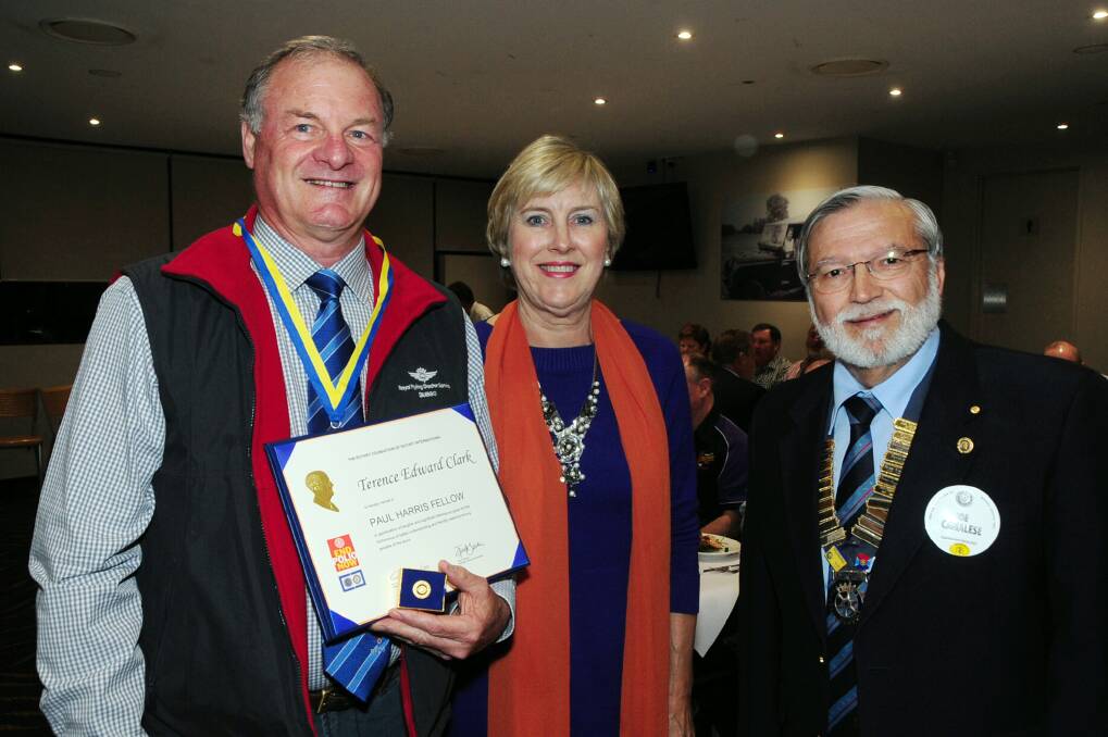 Terry Clark is congratulated on becoming a Paul Harris Fellow by his wife Sue Clark and Joe Canalese. Photo: BELINDA SOOLE
