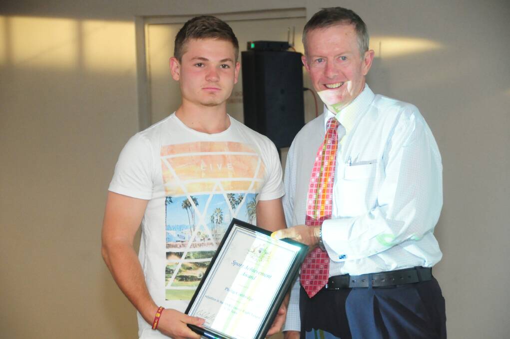 Phillip Combridge is presented with his Dubbo Sports award for rugby league by Member for Parkes Mark Coulton.