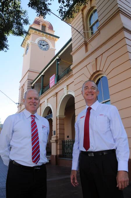 TOP: Selling agents Andrew McDonald and Michael Carolan. 
Photo: BELINDA SOOLE 
BELOW: Post office during Dubbo's city declaration in 1966.  
LEFT: The post office clock town in 1904. 
BELOW?LEFT: Dubbo post office in 1916.