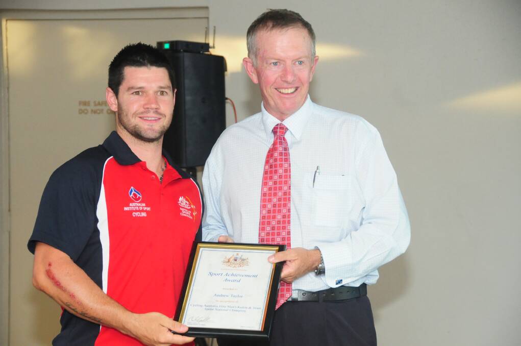 Mark Coulton presents Andrew Taylor with his award for cycling after an extremely successful season.