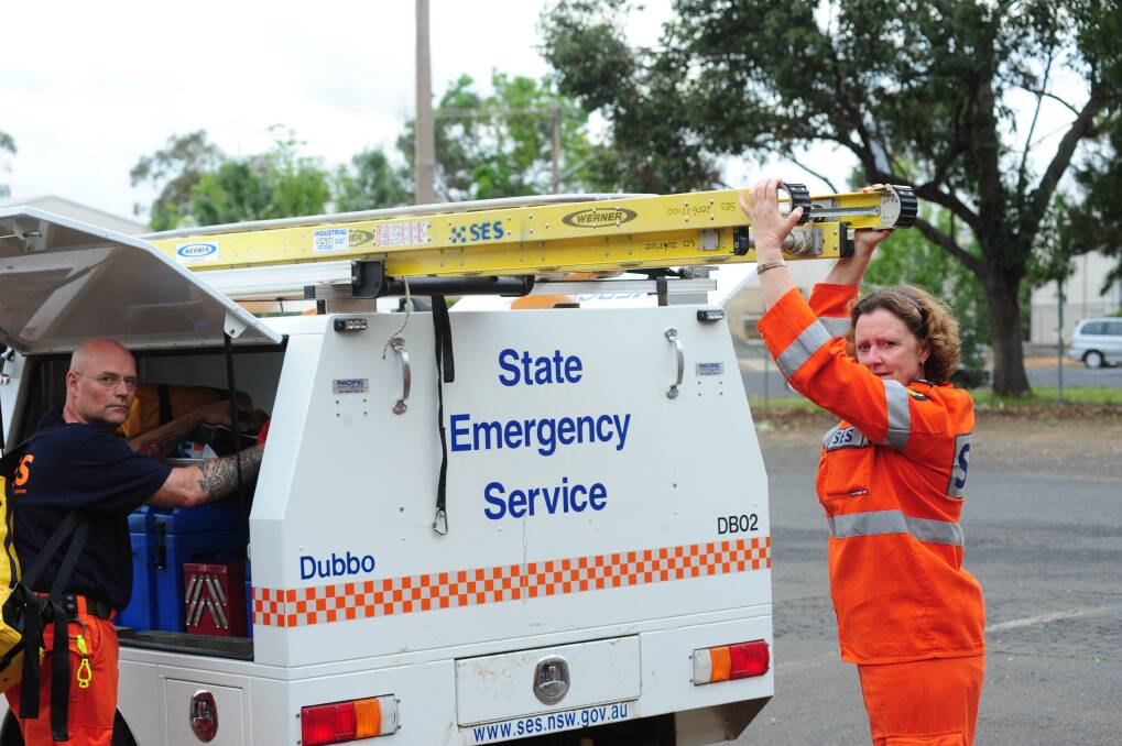 SES volunteers Wally Schloeffel and Denise Alley getting ready for action last year. The Dubbo City branch is keen for more members. Photo: LOUISE DONGES