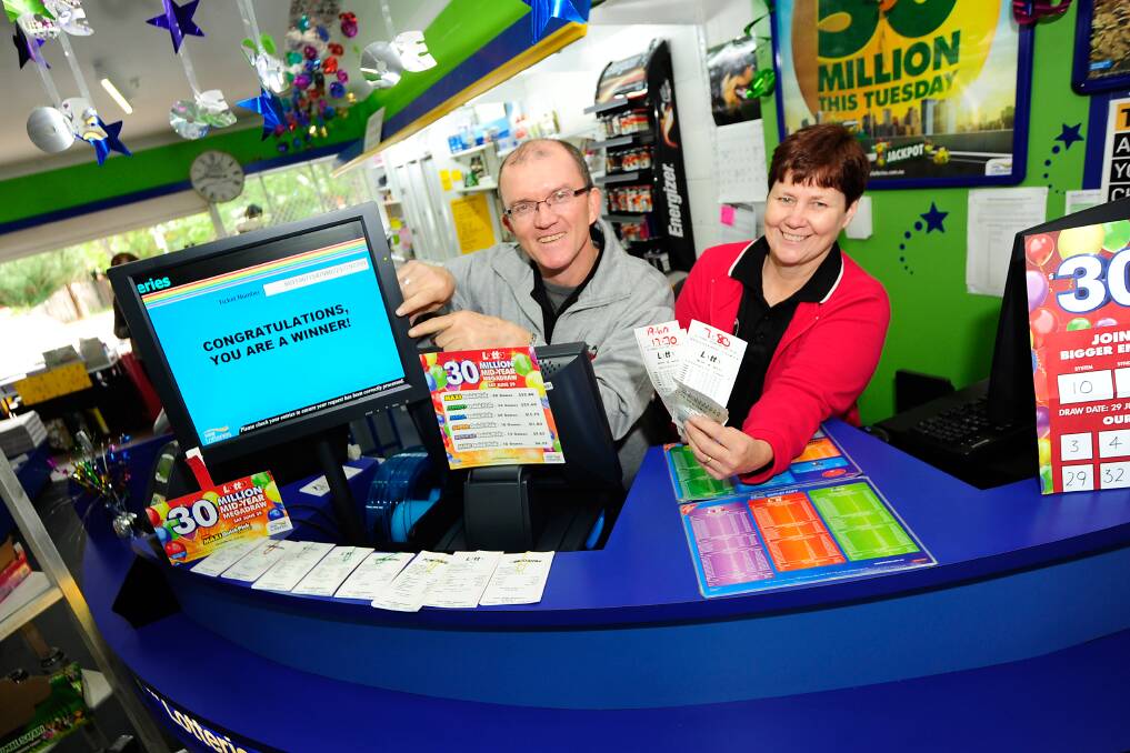 Andrew Bartlett and Debbi Bock at South Dubbo Newsagency celebrating after selling an as-yet unclaimed winning $5 Jackpot ticket worth $200,000.	Photo: BELINDA SOOLE