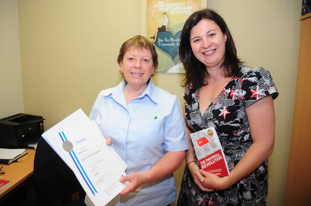 Australia's first qualified payroll manager Debbie Gray receives the Diploma of Payroll Management certificate from Tracy Angwin. 	Photo: BELINDA SOOLE